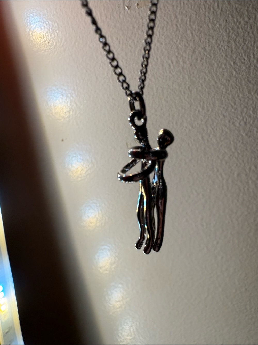 Silver Tone Embrace Pendant Necklace